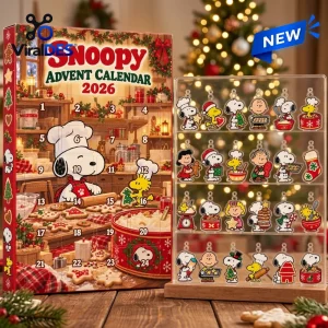Front view of a Snoopy 2026 Advent Calendar Blind Box next to a transparent display case filled with charms.