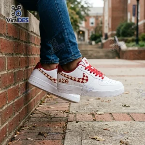 Lifestyle view of Delta Sigma Theta Custom Air Force 1 Sneaker worn with blue jeans near a brick wall.