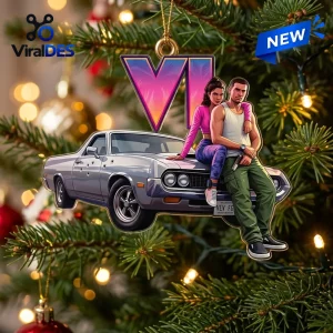 Close-up of a Grand Theft Auto VI Car Christmas Ornament hanging on a pine tree with lights.
