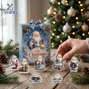Front view of Santa Claus Snow Globe Advent Calendar box with small figurines arranged on a wooden table.