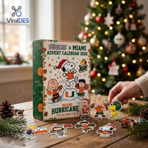 Front view of Peanuts x Miami Hurricanes 2026 Advent Calendar box on a wooden table with cartoon character ornaments.