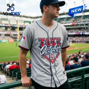 Man wearing a Cleveland Guardians Take October 2026 Gray Baseball Jersey at a stadium.