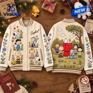 Front and back view of a cream varsity jacket with floral sleeves and cartoon character graphics.