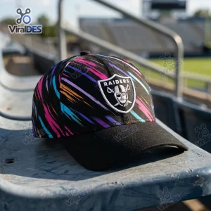 Front view of the Las Vegas Raiders black cap featuring a colorful abstract paint stroke pattern.