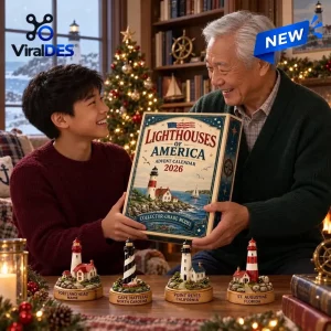 An older man and a boy holding the Lighthouses Of America 2026 Advent Calendar with four lighthouse models on the table.