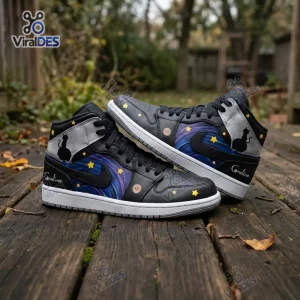 Side view of Coraline Black Cat Starry Night Air Jordan 1 Sneakers resting on a wooden plank outdoors.