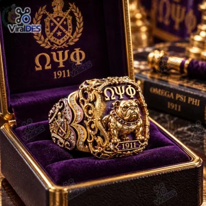 Closeup of the Omega Psi Phi Gold Bulldog Ring resting inside a purple and gold velvet lined box.