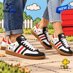 Side view of Snoopy x Woodstock Leather Samba Sneakers worn with blue jeans.
