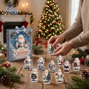 Close-up view of hands unboxing figurines from a Santa Claus Snow Globe Advent Calendar on a wooden table.