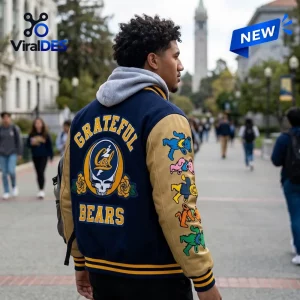 Rear view of a man wearing a California Golden Bears Grateful Dead baseball jacket on a campus pathway.