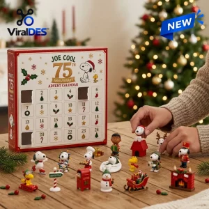 Front view of Peanuts Joe Cool 75th Anniversary Christmas Advent Calendar with miniature figures displayed on a wooden table.