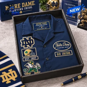 Top view of a Notre Dame Fighting Irish Camp Hawaiian Shirt folded inside a display box with team logos.