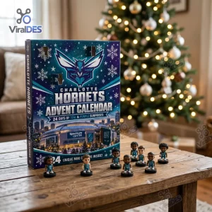 Front view of Charlotte Hornets 2026 Advent Calendar on a wooden table with miniature figures in front and a lit Christmas tree background.