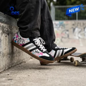 Lifestyle view of Blink-182 Smiley Adidas Samba Shoes worn with dark pants at a skatepark.