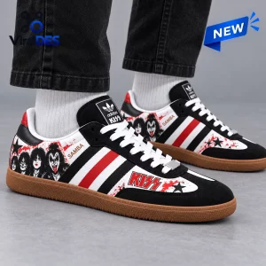 Side view of KISS Black Samba OG Shoes featuring rock band graphics and red stripes worn with dark jeans.