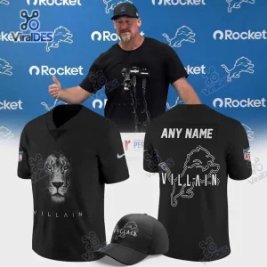 Detroit Lions Villain Black Custom Football Jersey mockup with front, back, and cap views against a press backdrop.