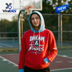 Front view of a woman wearing an Atlanta Dream 2026 WNBA Finals red hoodie with a blue hood on a basketball court.