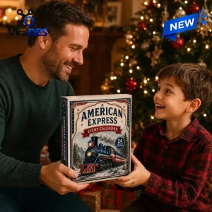Father and son holding an American Express Advent Calendar box near a Christmas tree.