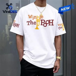 Front view of a person wearing a Winnie the Pooh white shirt with brown text and yellow trumpet graphic.