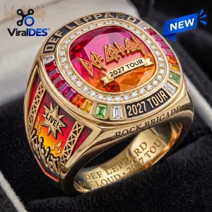 Closeup of the Def Leppard 2027 Tour Championship Ring featuring a large red gem, colorful stones, and engraved text.