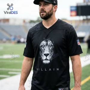 Man wearing a Detroit Lions Villain Black Custom Football Jersey featuring a lion graphic on the field.