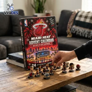 Hand placing miniature basketball figurine on wooden table next to Miami Heat Basketball Advent Calendar 2026 box.