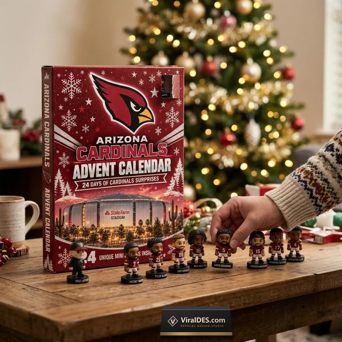Arizona Cardinals 2026 Advent Calendar box with an open compartment door as a hand arranges miniature player figurines on a wooden table