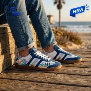 Lifestyle view of The Beach Boys Samba Sneakers worn with blue jeans on a wooden boardwalk near the ocean.