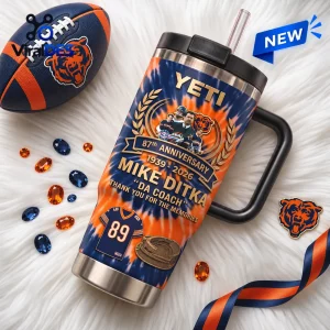 Front view of Mike Ditka Chicago Bears 87th Anniversary Tumbler with handle, straw, and football graphic on furry white rug.