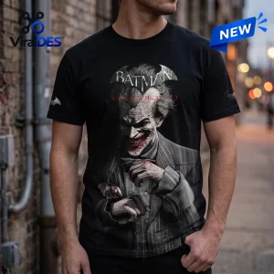 Front view of a black Batman Arkham City 15th Anniversary T-Shirt featuring a graphic of a smiling man in a suit.