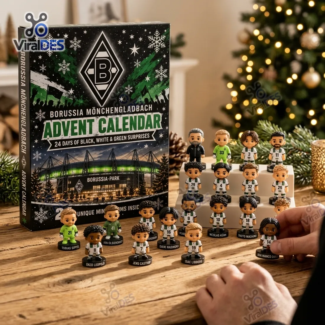 Arranging freestanding Borussia Monchengladbach 3D player figurines on a wooden table in front of the advent calendar box