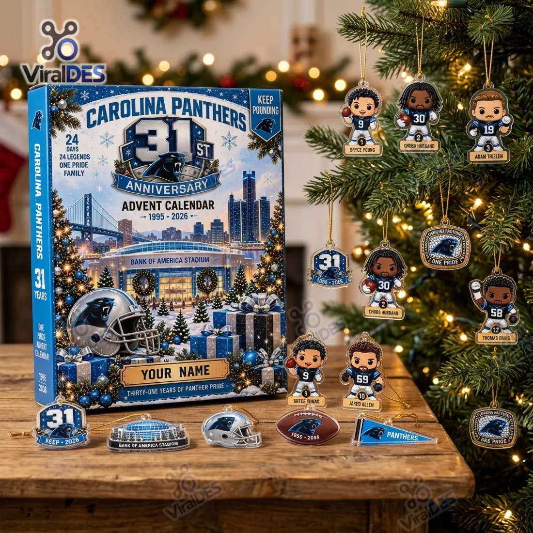 Carolina Panthers 31st Anniversary Advent Calendar standing on a wooden table beside a Christmas tree hung with flat acrylic player and stadium ornaments