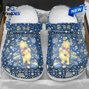 Front view of Winnie-the-Pooh Glitter Clogs in blue with honeycomb patterns and character graphics.