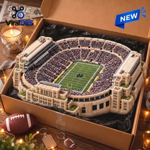 Top view of a Notre Dame Fighting Irish plush stadium pillow inside a gift box with football accessories.