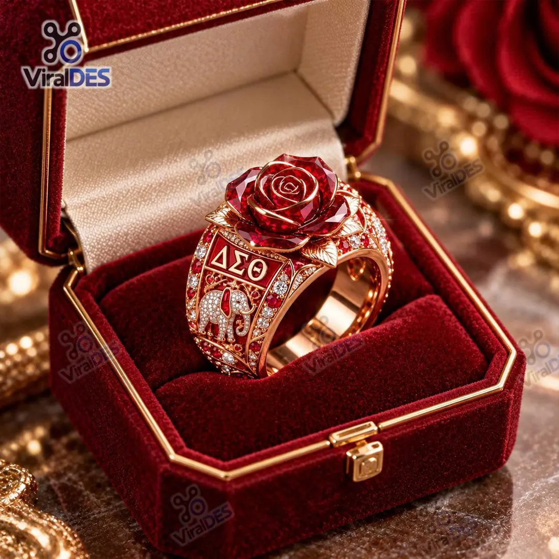 Delta Sigma Theta Rose Gold Elephant Ring resting in a crimson velvet presentation box highlighting the faceted red rose crown and ΔΣΘ elephant shank