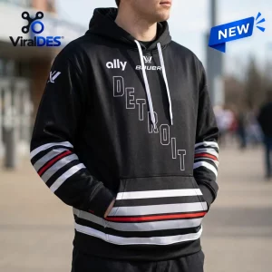 Front view of a person wearing a PWHL Detroit Hockey 2026 black hoodie with red and white sleeve stripes.