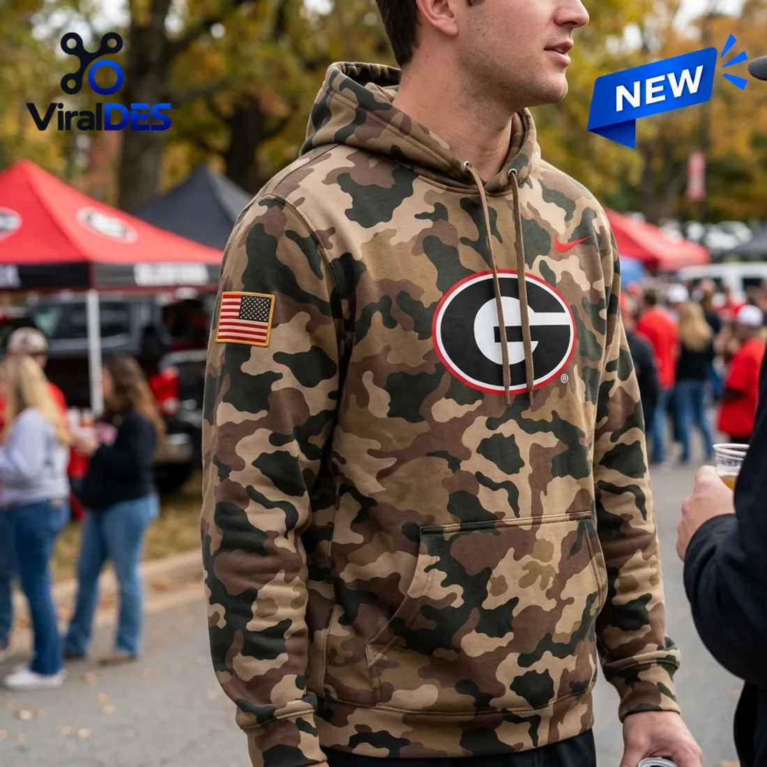 Tailgate side-angle view of the Georgia Bulldogs 2026 Military Appreciation Camo Hoodie highlighting the American flag sleeve patch and front kangaroo pocket