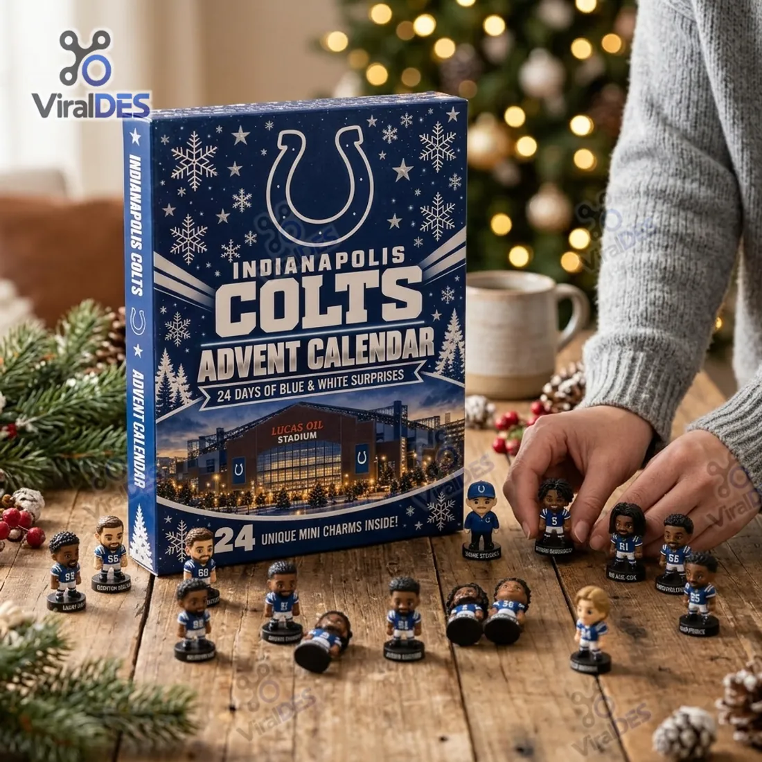 Collector arranging freestanding 3D Indianapolis Colts miniature player figurines on a rustic wood tabletop beside the Lucas Oil Stadium advent calendar box