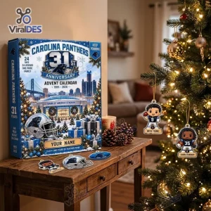 Carolina Panthers 31st Anniversary Advent Calendar displayed on a wooden table next to a Christmas tree.