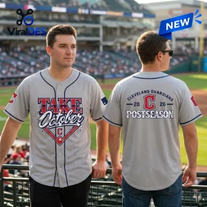Man wearing the Cleveland Guardians Take October 2026 Gray Baseball Jersey in a stadium setting.