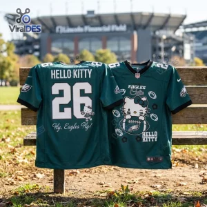 Front and back view of a green Hello Kitty x Philadelphia Eagles football jersey on a wooden bench.