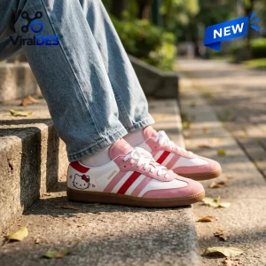 Side view of Hello Kitty Adidas Samba pink shoes worn with light wash jeans on outdoor steps.