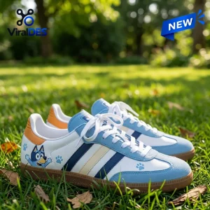 Pair of Bluey x Adidas Samba Light Blue Shoes resting on green grass outdoors.