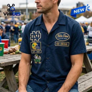 Front view of a man wearing a dark blue Notre Dame Fighting Irish Camp Hawaiian Shirt at a tailgate party.