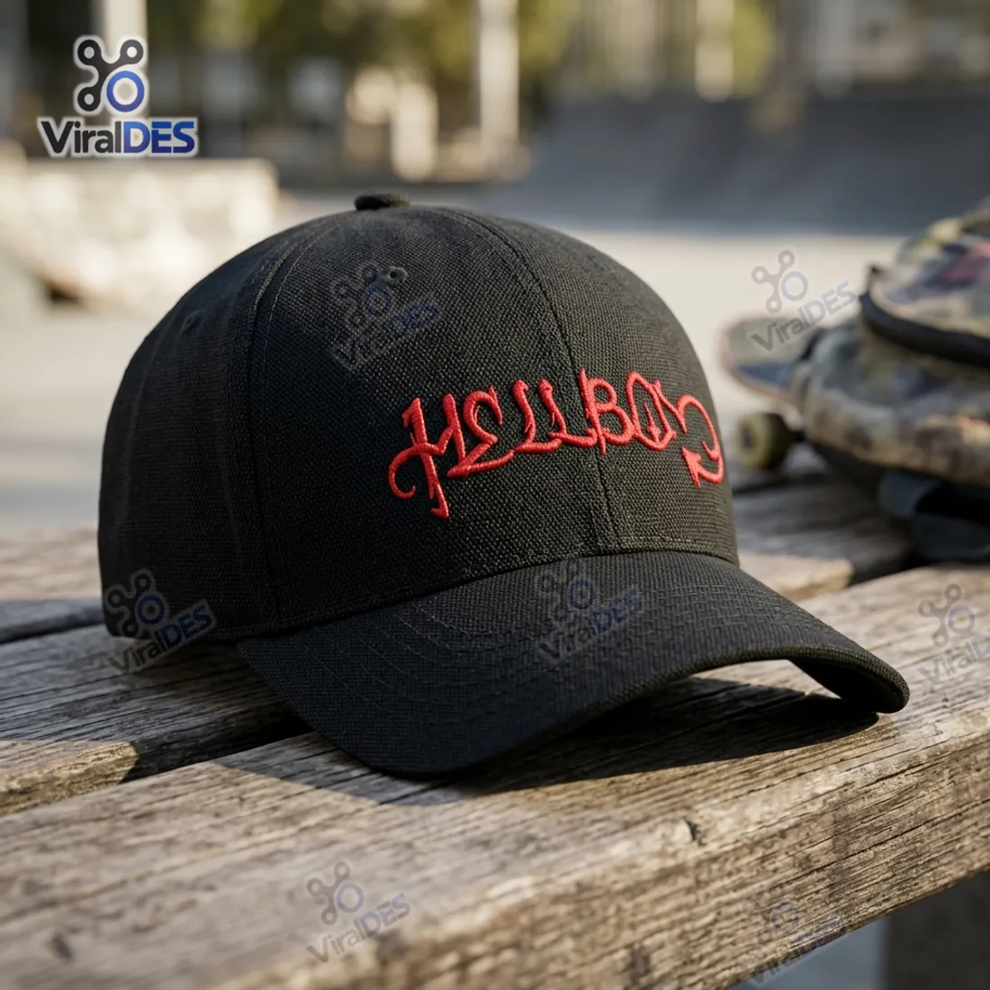 Lil Peep Hellboy Black Classic Cap resting on a wooden bench at an outdoor skatepark showing the red devil-tail lettering and structured black canvas crown