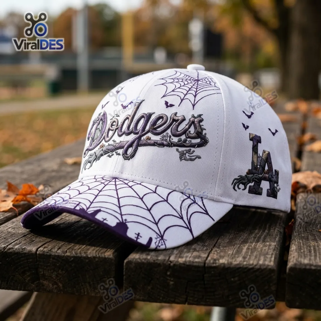 Angled view of the Los Angeles Dodgers Nightmare Halloween Baseball Cap showing the skeletal hand gripping the LA monogram and purple spiderweb brim
