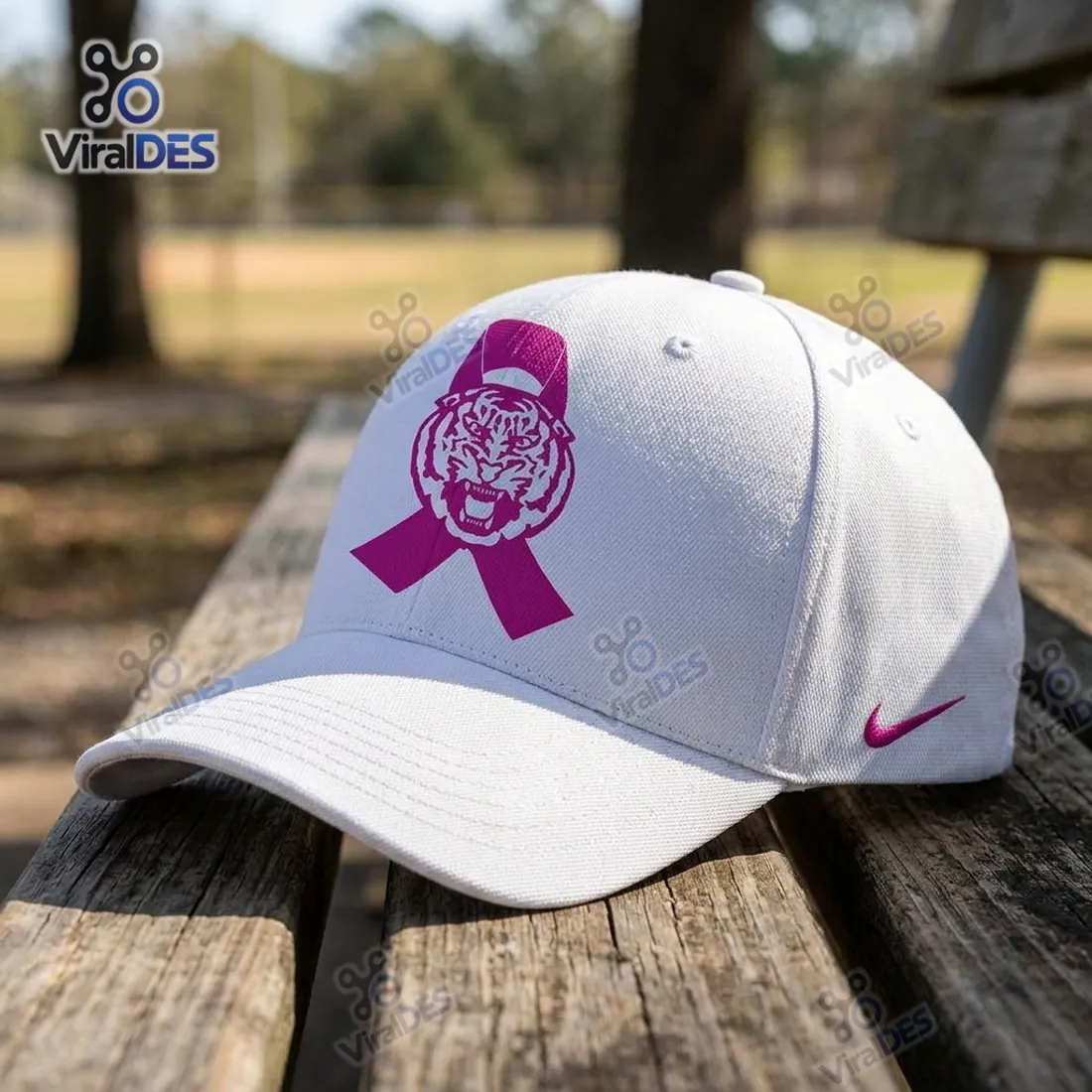 Louisiana State University Tigers Pink Ribbon Baseball Cap resting on a wooden park bench displaying the white canvas weave and magenta Tiger ribbon emblem