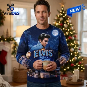 Front view of a man holding a mug while wearing an Elvis Presley Blue Christmas ugly sweater indoors.
