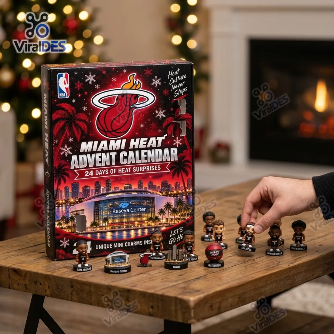 Collector placing freestanding 3D Miami Heat miniature player figurines and sculpted Kaseya Center and skyline pedestals on a wooden table beside the advent calendar box
