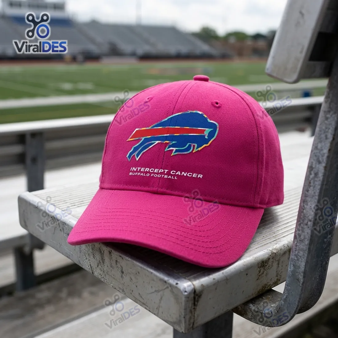 NFL Crucial Catch Buffalo Bills Pink Cap resting on metal stadium bleachers featuring the charging blue bison logo with multi-color outline